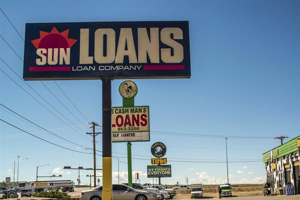 An NBC News photo of several payday loan signs along a Gallup, NM thoroughfare