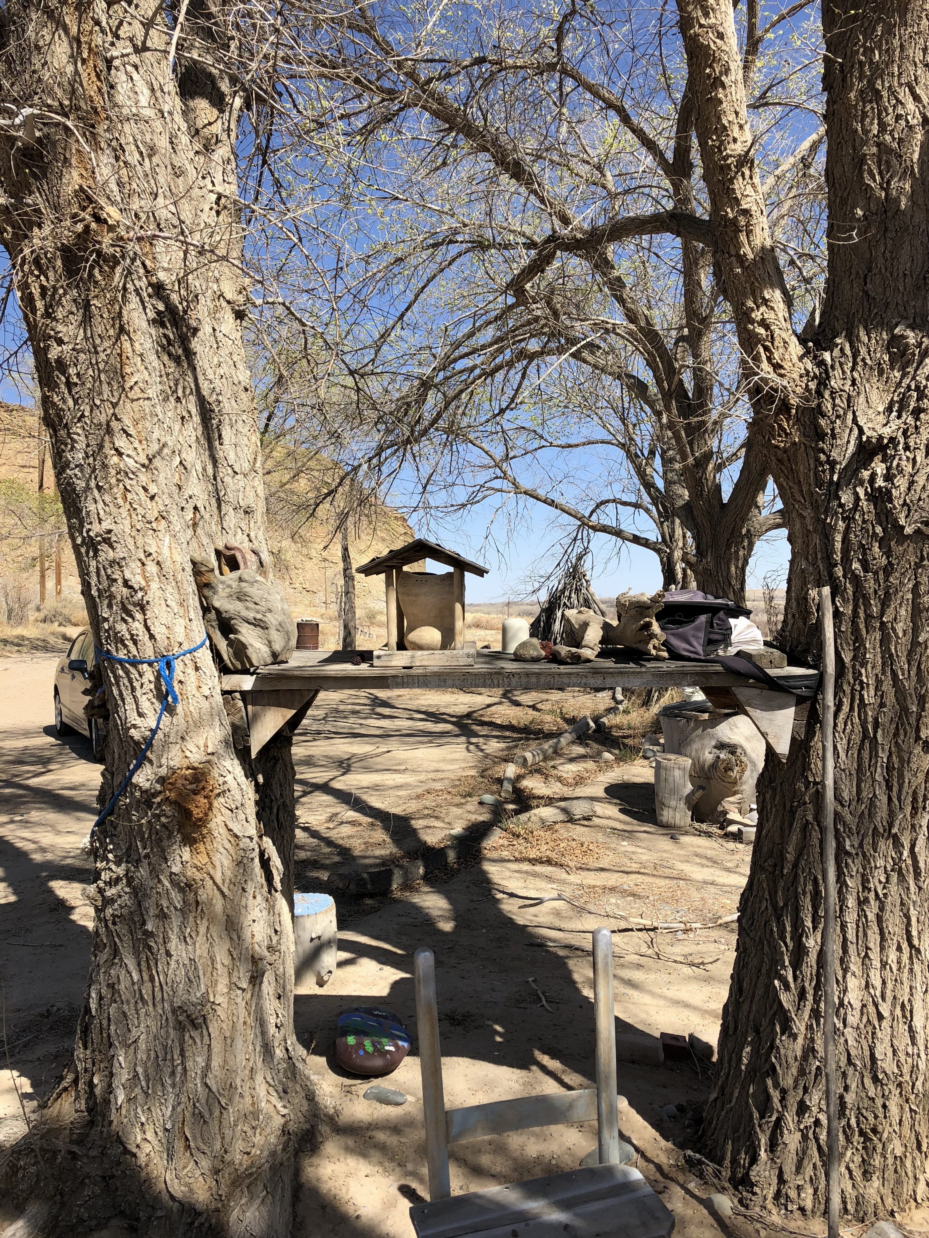 Outdoor display of Gloria Emerson's wood and stone collectibles