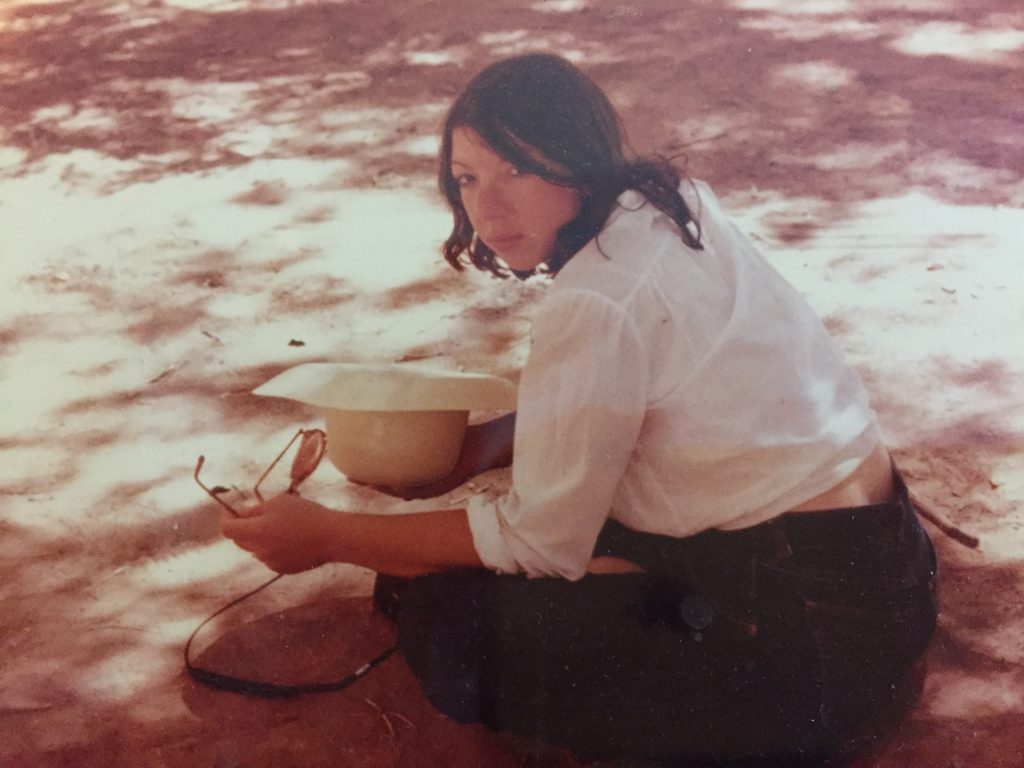 The author in her youth, sitting in the shade in Canyon de Chelly, Navajoland